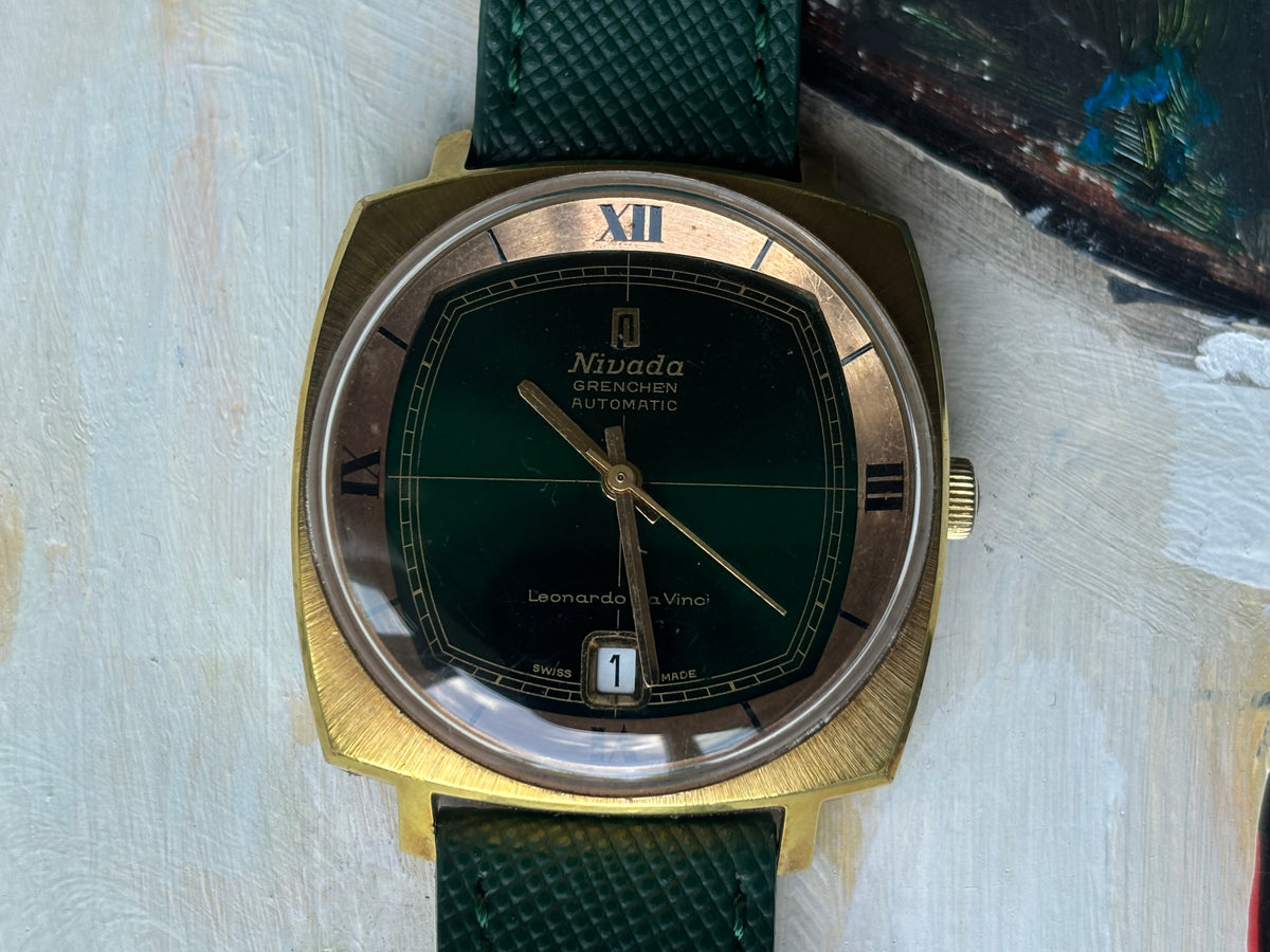 Close-up of Nivada Grenchen Leonardo Da Vinci automatic green dial with Roman numeral chapter ring and date at 6 o’clock
