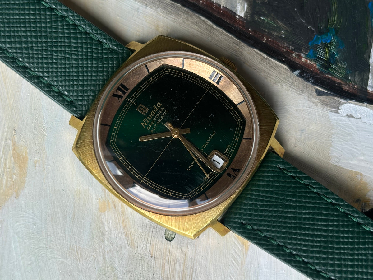 Nivada Grenchen Leonardo Da Vinci automatic shown diagonally on a green leather strap