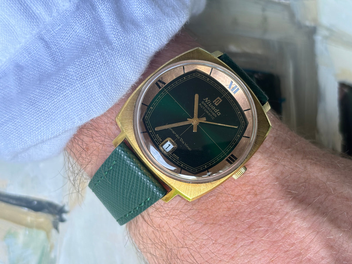 Wrist shot of vintage Nivada Grenchen Leonardo Da Vinci automatic with dark green dial and date display
