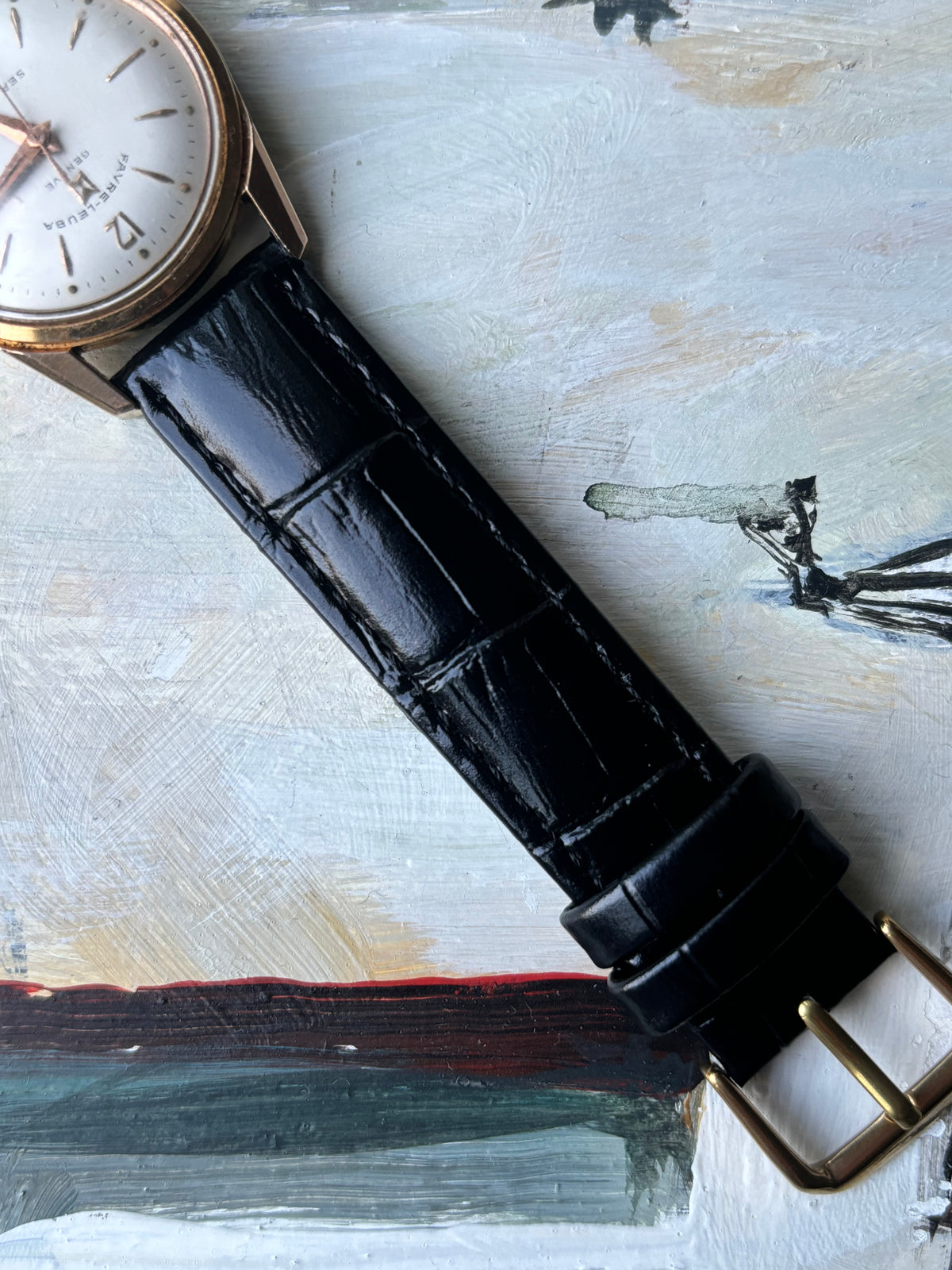 Detail of the black leather strap and gold-tone case of the Favre-Leuba Genève Sea King.