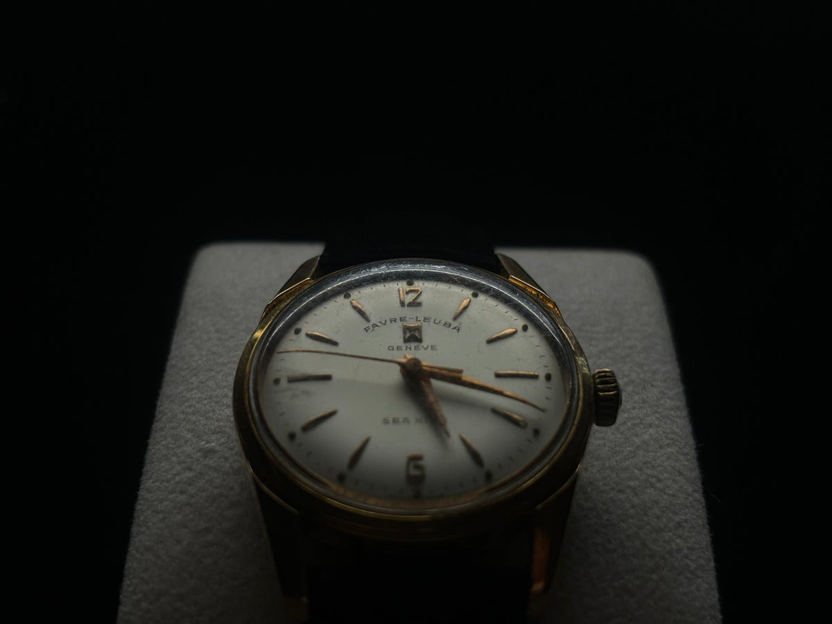 Studio front view of the vintage Favre-Leuba Genève Sea King against a dark background.