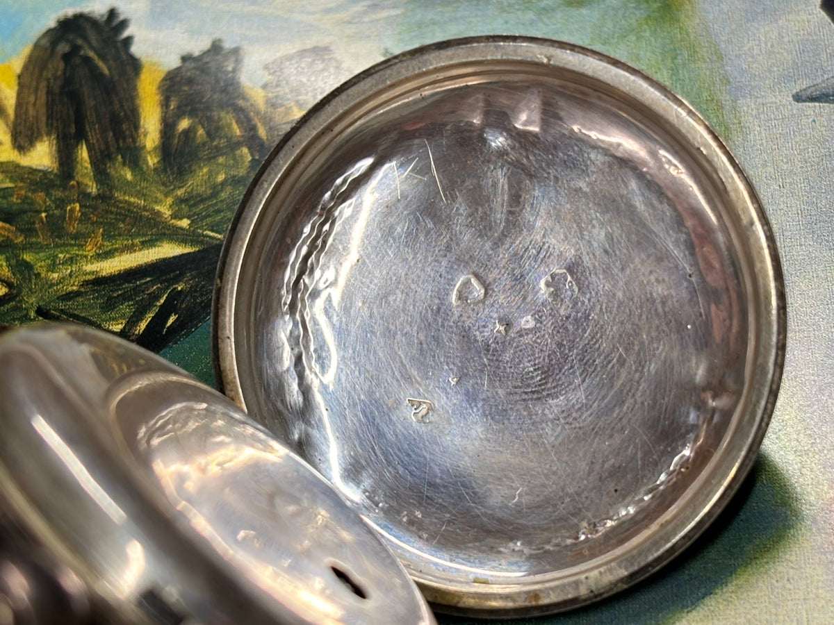 Interior caseback of an antique John Bennett London pocket watch.