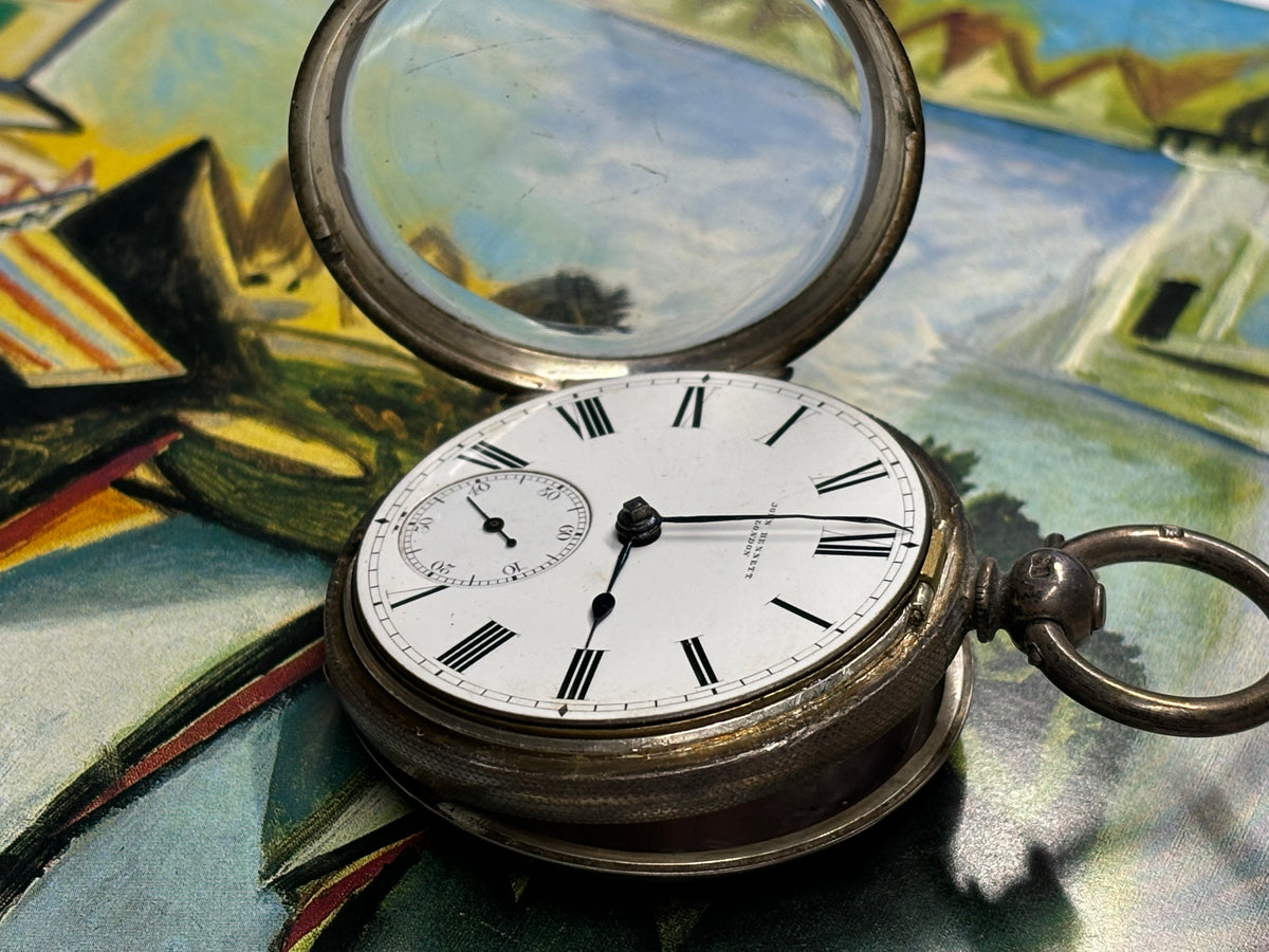 Antique John Bennett London pocket watch photographed with its front cover open.