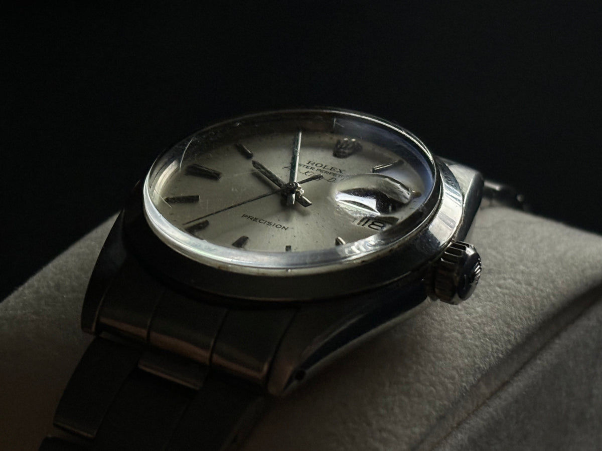 Three-quarter studio view of Rolex Air-King-Date Precision ref. 5700 with date window at 3 o’clock
