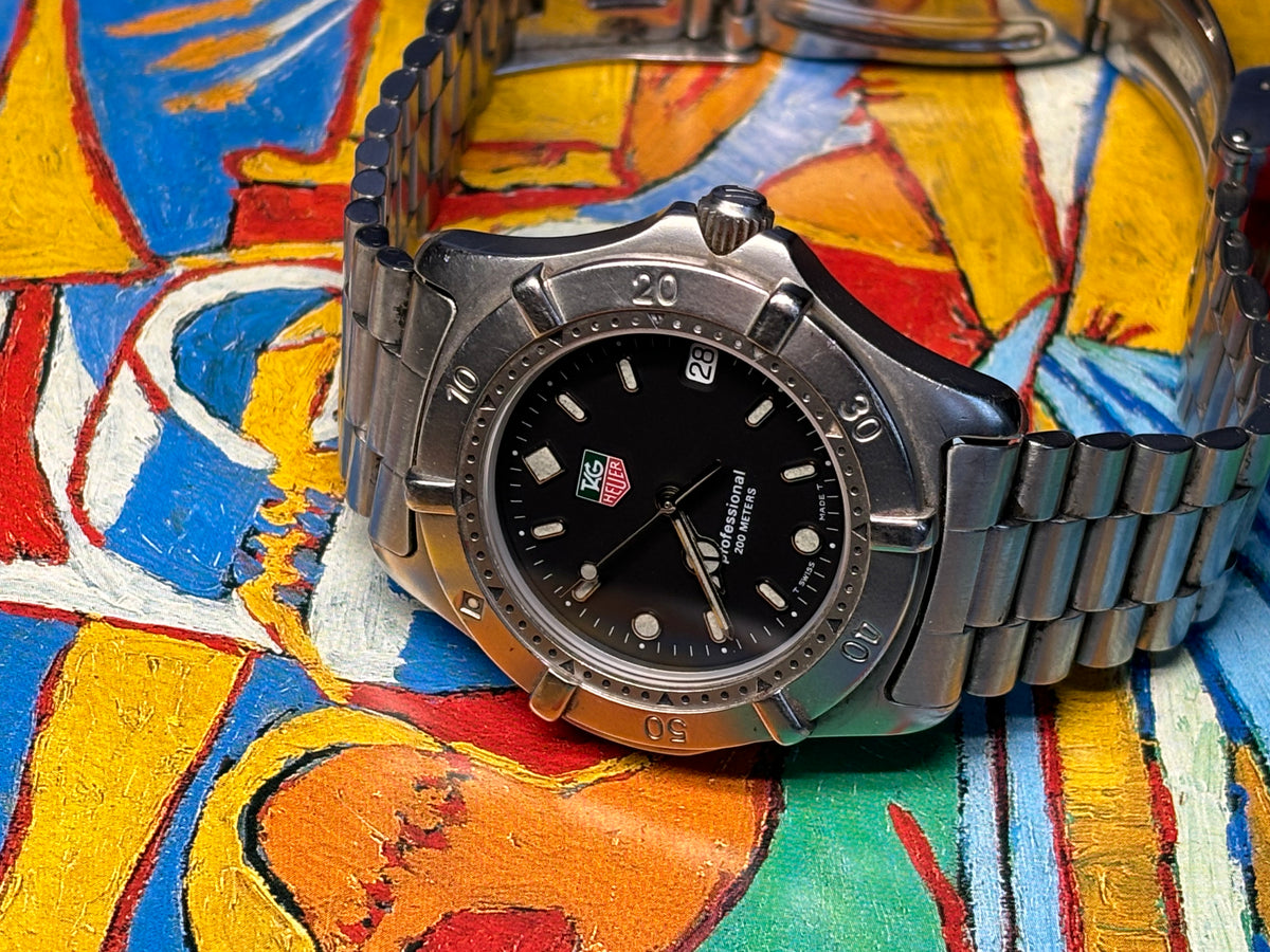 Vintage TAG Heuer Professional 200 Metres watch showing its black dial, bezel and bracelet.