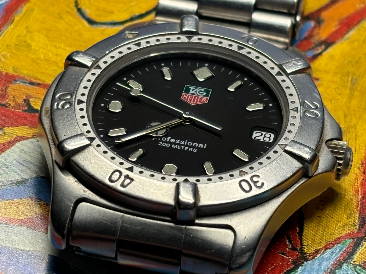 Close-up of the dial and rotating bezel on a vintage TAG Heuer Professional 200 Metres watch.