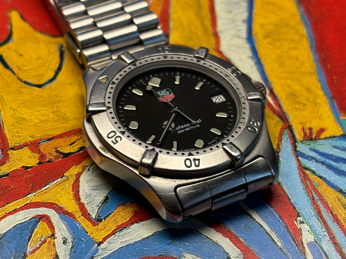Angled front view of a vintage TAG Heuer Professional 200 Metres stainless-steel watch.