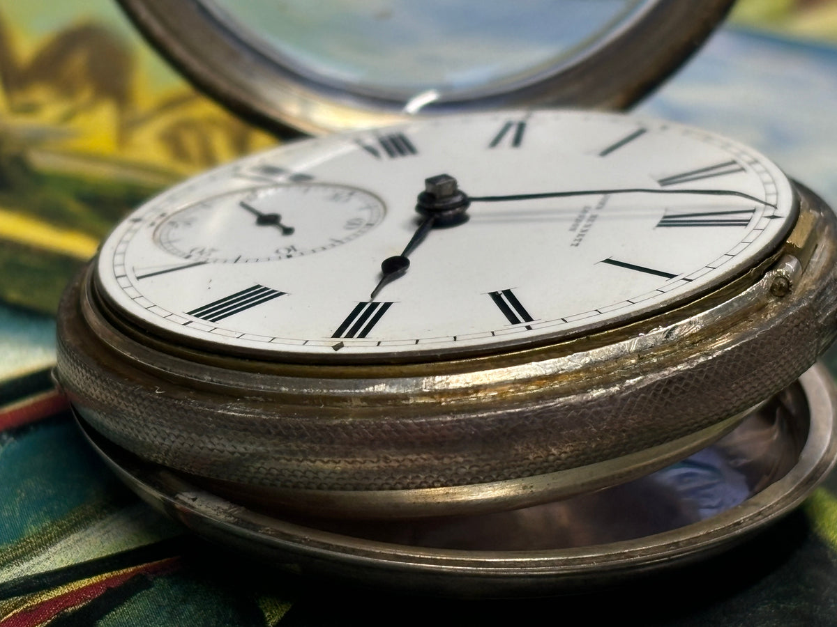 Side profile of an antique John Bennett London pocket watch with hinged cover open.