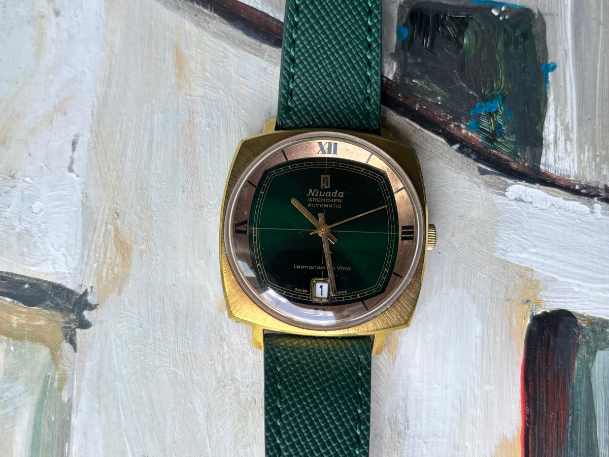 Nivada Grenchen Leonardo Da Vinci automatic watch with dark green crosshair dial, gold-tone case and green leather strap