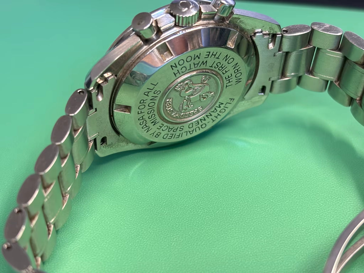 Rear view of an Omega Speedmaster Professional Moonwatch caseback and stainless-steel bracelet.