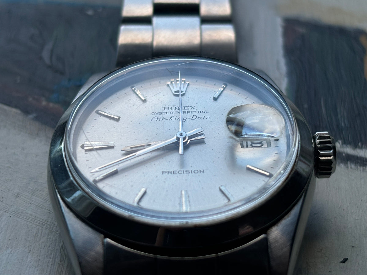 Rolex Air-King-Date Precision ref. 5700 showing silver dial, applied baton markers and magnified date display