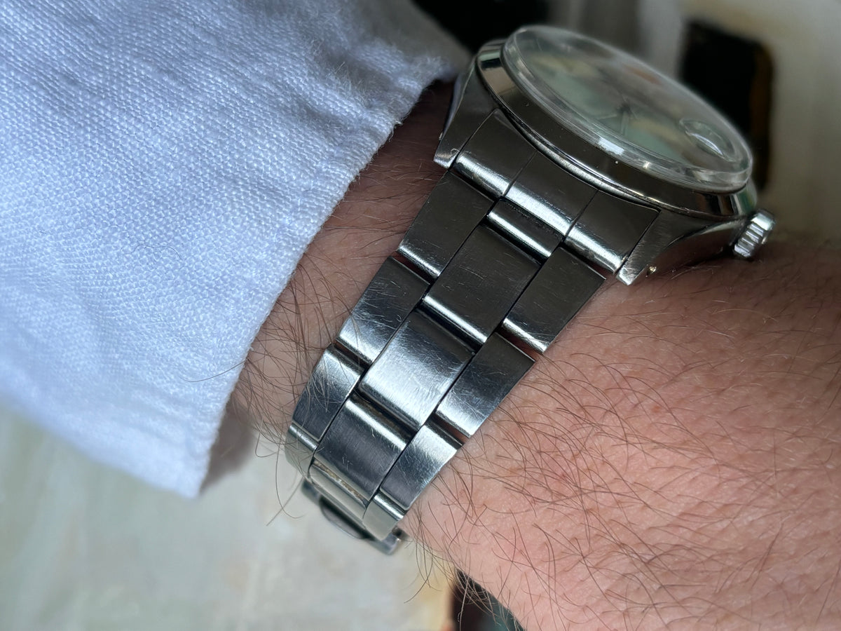 Side wrist view of Rolex Air-King-Date Precision ref. 5700 showing Oyster bracelet and polished case profile