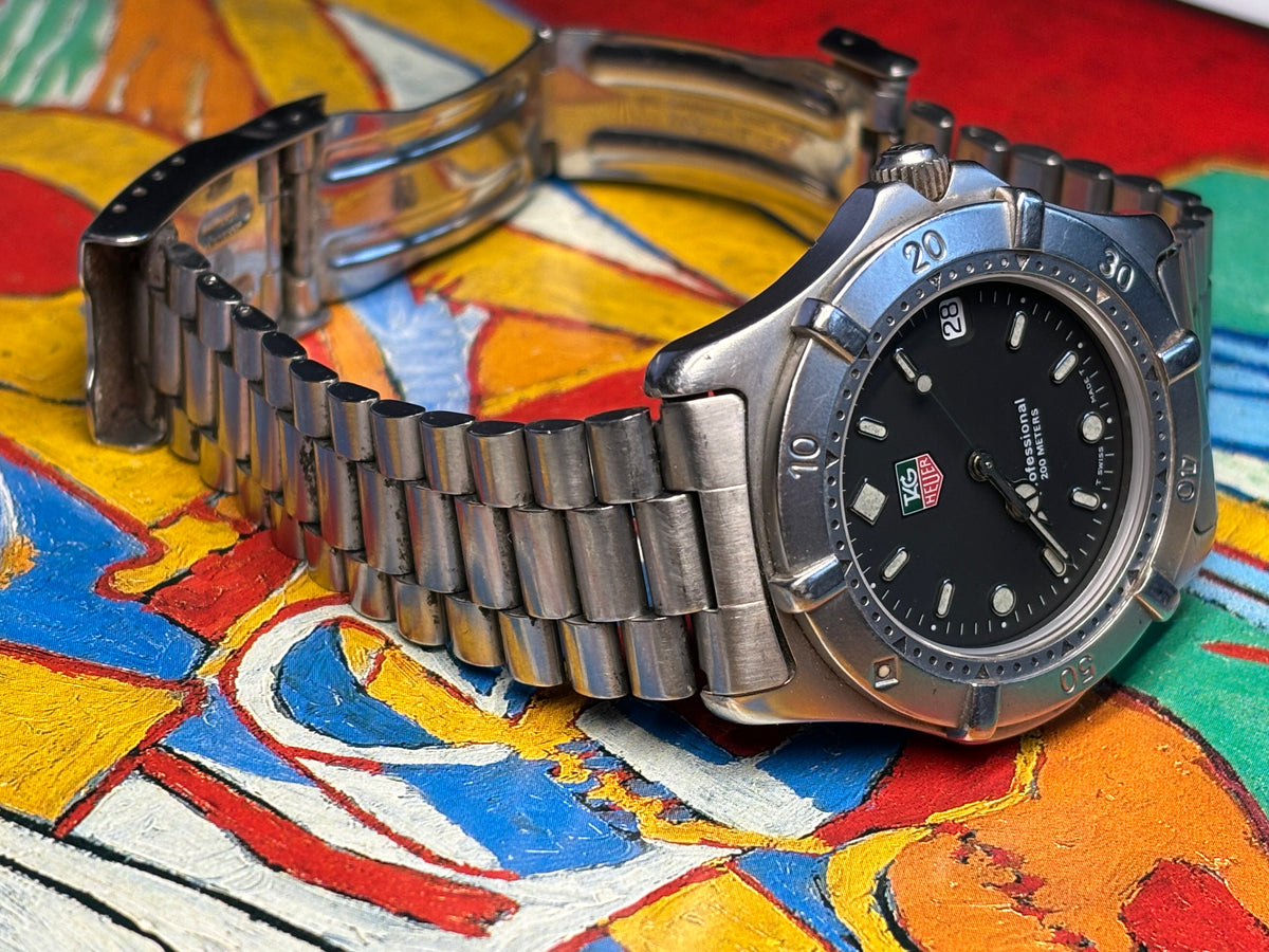 Vintage TAG Heuer Professional 200 Metres watch shown with its full stainless-steel bracelet.